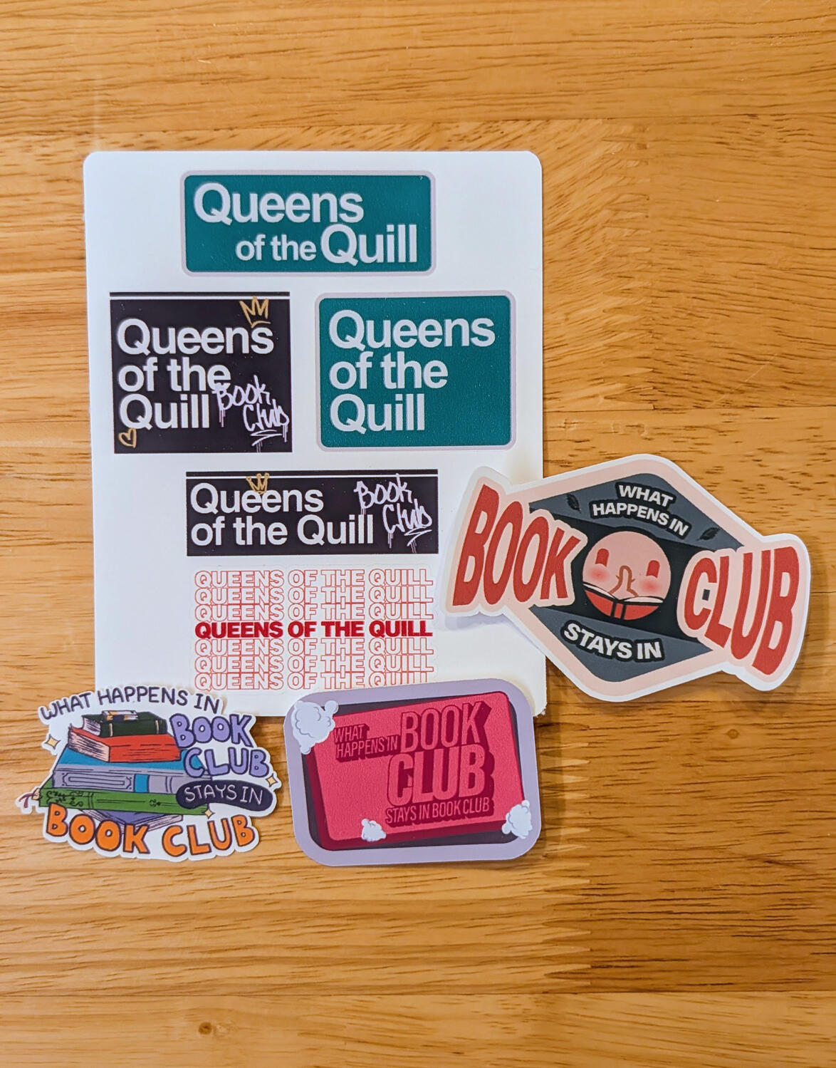 Queens of the Quill customized stickers A sticker sheet with variations of "Queens of the Quill" done in NYC style signage. Around the sheet has various sticker designs that read "What happens in book club stays in book club."